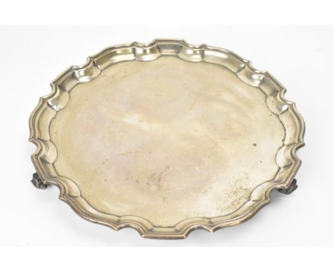 A George V silver salver, by S Blanckensee &amp; Son Ltd, hallmarked Chester 1926, having a Chippendale border and raised on 