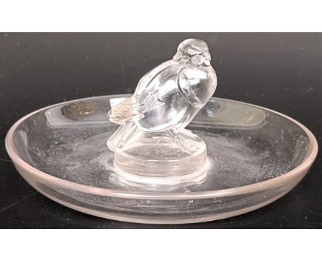 An R Lalique glass pin dish decorated a bird, engraved R Lalique to base, 12 cm diameterA hairline crack to the base, some li