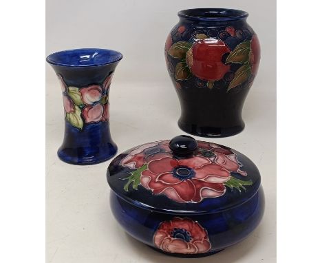 A Moorcroft Pottery pomegranate pattern vase, 14.5 cm high, another Moorcroft Pottery vase, 11 cm high and a Moorcroft Potter