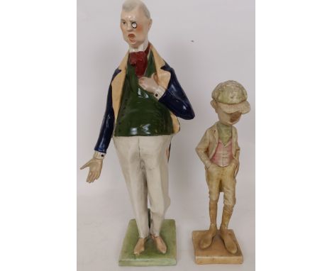 A late 19th century porcelain figure of a gentleman, wearing a monocle, 40 cm high, and a comical figure of a man smoking a c