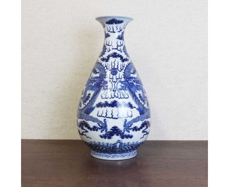 A large Chinese yuhuchun vase,the pear-shaped body rising from a circular foot to a flared rim, painted with two dragons chas