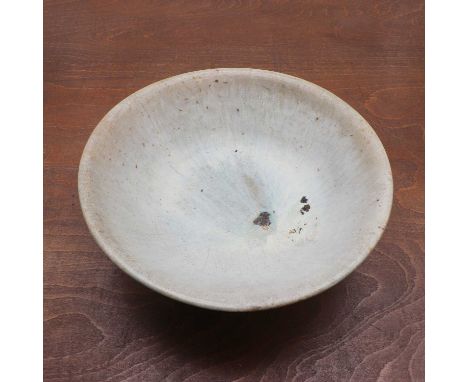 A Chinese blue-glazed bowl,Song-Yuan dynasties, the rounded sides rising from a circular foot, covered by a light blue glaze 