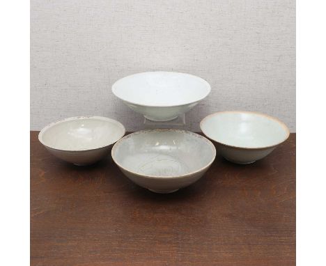 A collection of four Chinese stoneware bowls,Song dynasty (960-1279), each with rounded sides rising from a circular foot, wi