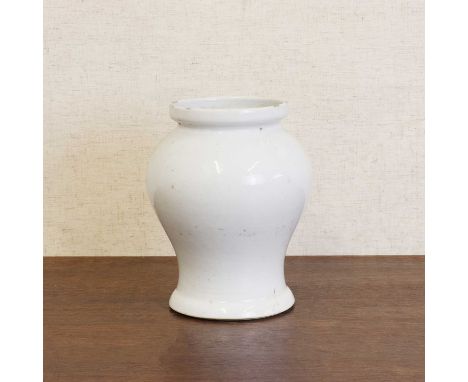 A Chinese white-glazed vase,Kangxi (1662-1722), of baluster form, incised with scrolling peony, a six-character Chenghua mark