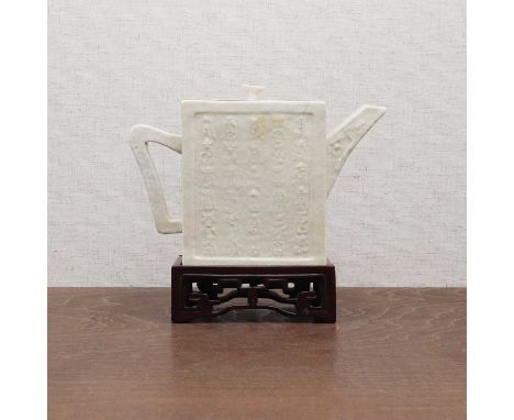 A Chinese white-glazed teapot,18th century, of rectangular form, each sided moulded with shou characters in various fonts, th