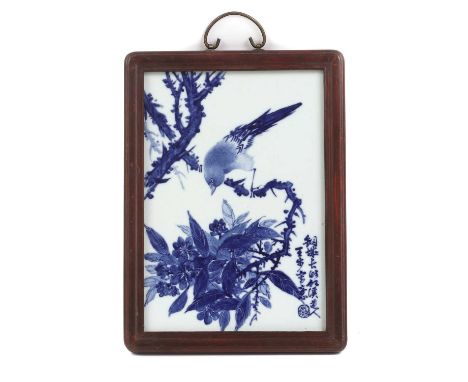 A Chinese blue and white porcelain plaque,20th century, of rectangular form, painted with a bird perched on a blossoming tree