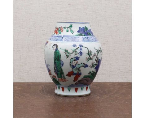 A Chinese wucai jar, Kangxi (1662-1722), of baluster form, painted with a lady and boys in a garden, 16.5cm high清康熙 五彩教子夺魁图莲子