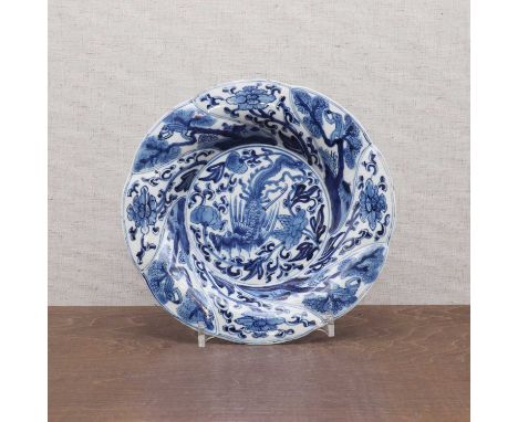 A Chinese blue and white plate,Kangxi (1662-1722), of lobed form, the centre painted with a phoenix surrounded by peony, encl