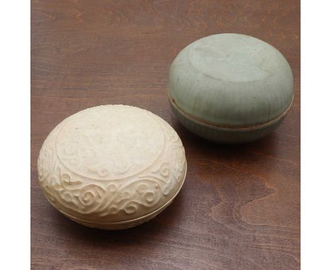 A Chinese stoneware box and cover,Song-Yuan dynasty, of circular form moulded with peony enclosed by a scroll border, covered
