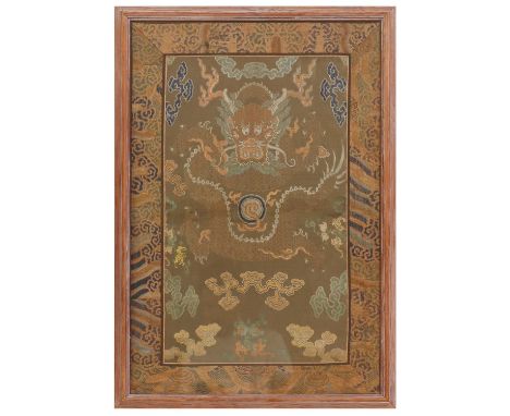 A Chinese brocade textile, Qianlong (1736-1795), of a front-facing dragon chasing a flaming pearl among clouds,74 x 48cm, fra