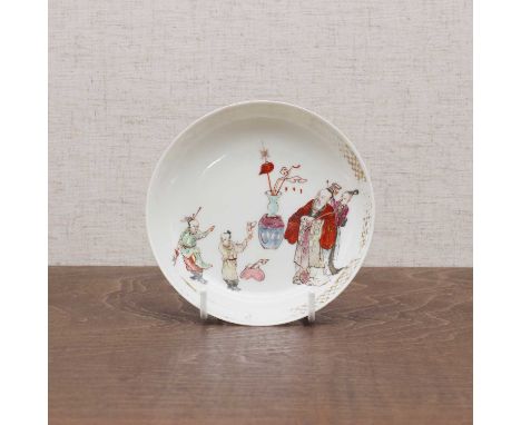 A Chinese famille rose saucer,Yongzheng (1723-1735), the rounded sides rising from a circular foot, painted with figures to t