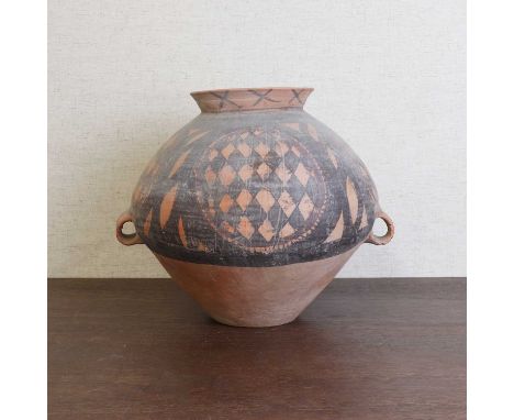 A Chinese pottery jar,Neolithic period (c.6500-1700 BC), the olive-shaped body with a wide everted neck and twin loop handles