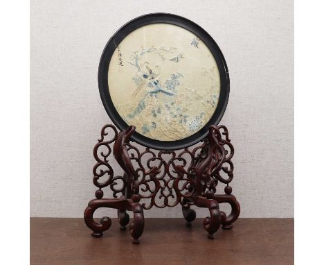 A Chinese table screen,late Qing dynasty, with an embroidery decorated with two pheasants perched on a rock under a blossomin