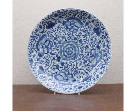 A Chinese blue and white charger,Kangxi, early 18th century, the rounded sides rising from a circular foot, painted with peon