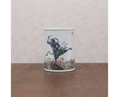 A Chinese wucai brush pot,Kangxi (1662-1722), of cylindrical form, painted with Kuixing, the God of Literature, standing with