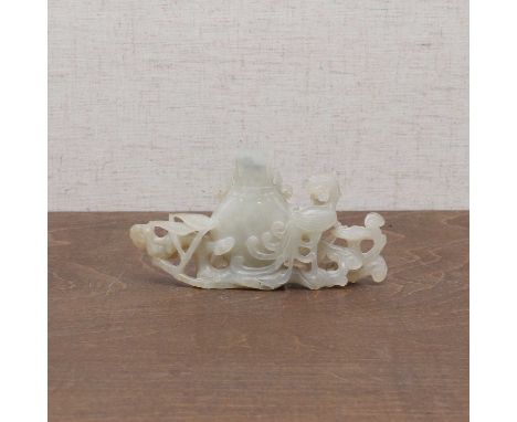 A Chinese jade group,late Qing dynasty, pierced and carved with a phoenix standing by a vase, surrounded by bamboo and lingzh