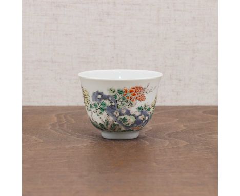 A Chinese wucai cup,Kangxi (1662-1722), the rounded sides rising from a circular foot to a flared rim, painted with peony by 