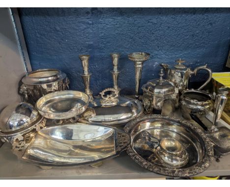 A selection of silver plated items to include a pair of candlesticks, a trumpet vase, a tea caddy with lion twin handles and 