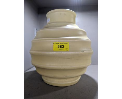 A Keith Murray for Wedgwood Art Deco ribbed globe vase glazed in straw yellow and bearing the KM mark and stamped Wedgwood on