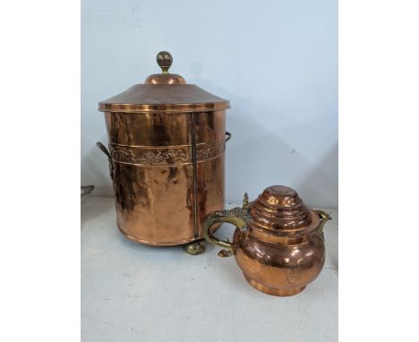 A copper and brass fire bin with floral embossed decoration on three brass feet and brass finial with twin handles, along wit