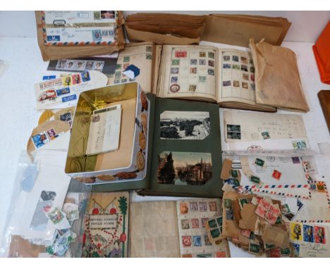 A large collection of stamps, some loose, some in albums, to include examples from Japan, India, Belgium and others, along wi