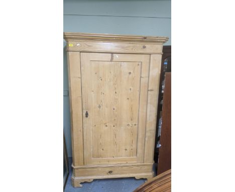 A Victorian pine single wardrobe, stepped cornice above a panelled door, the base standing on bracket feet, 193 x 123 x 63cms