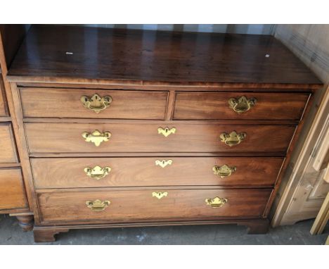 A George III style mahogany chest of two short and three long graduating drawers having brass drop handles and on bracket sha