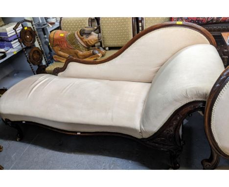 A Victorian scroll end chaise longue on cabriole legs with machine carved support, flanked by poker work with overstuffed and