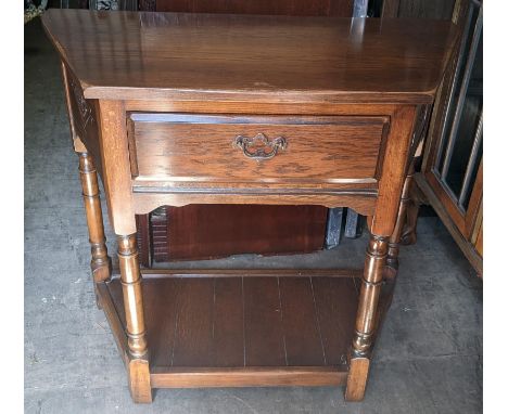 A 17th century style oak table having a single drawer on turned legs and shelf below 76.5cm h x 84cm w Location: R ConIf ther