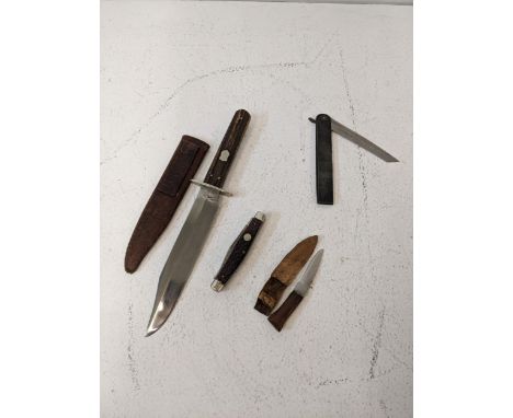 A collection of knives to include a British bone handled dagger with a leather sheaf, a cut throat razor, a German penknife a