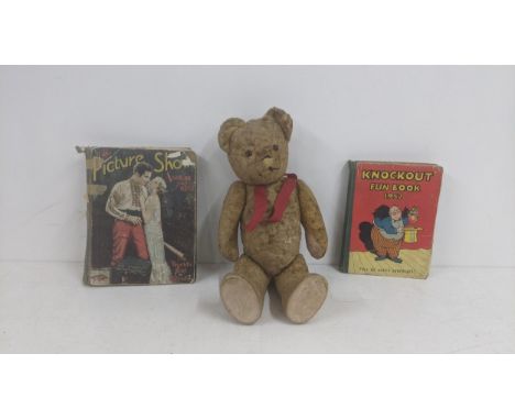 A 1930's Teddy  Bear with golden mohair fur stuffed with growl, glass eyes, jointed limbs along with two vintage booksLocatio