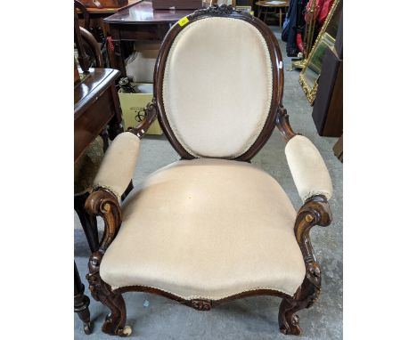 Victorian mahogany upholstered open armchair, carved crest rail, scrolled end arms, on similarly carved French cabriole legs 