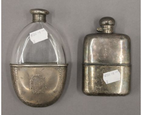 A silver mounted hip flask and a plated hip flask. The former 14.5 cm high.