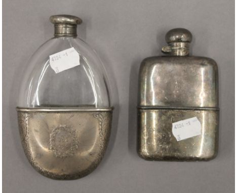 A silver mounted hip flask and a plated hip flask. The former 14.5 cm high.