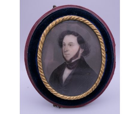 A cased 19th century miniature portrait of a bearded gentleman. 7.5 cm high.
