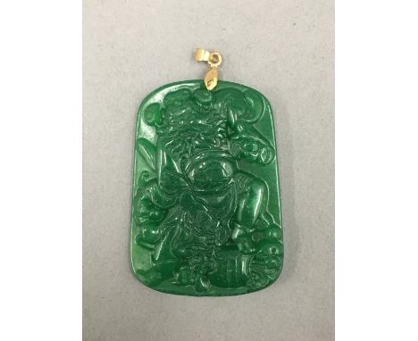 A Chinese jade pendant with small gold mounts. 5.5 cm high.