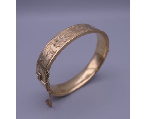 A 9 ct gold bangle form bracelet. 6.5 cm wide. 19.6 grammes.