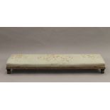 A Victorian tapestry covered foot stool. 112 cm long.