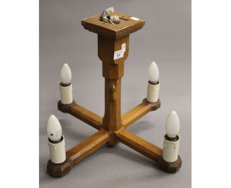 A Mouseman carved oak four branch hanging light. 39.5 cm high.