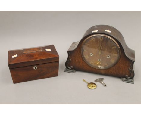 A Victorian rosewood tea caddy and an oak mantle clock. The former 23 cm wide.