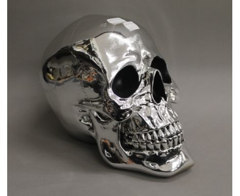A silvered skull. 19 cm high.