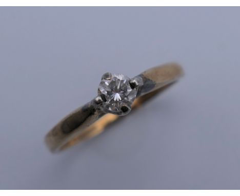 A 9 ct gold diamond solitaire ring. Ring size M/N. 1.9 grammes total weight.