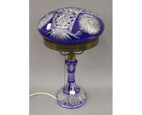 A blue flashed cut glass table lamp. 45 cm high.