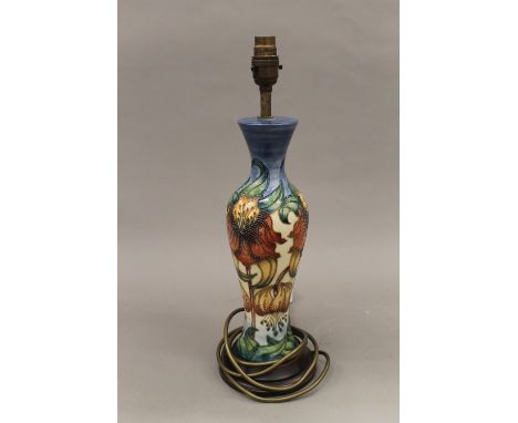 A Moorcroft Anna Lily table lamp by Nicola Slaney with matching silk shade. The lamp 43 cm high overall.