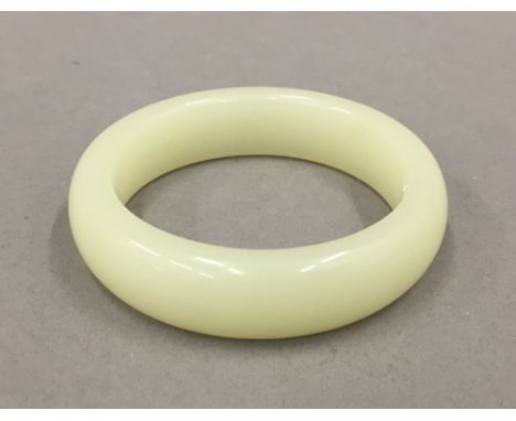A jade bangle. 8 cm diameter.