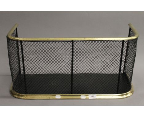 A 19th century brass and iron fender. 64 cm wide, 31 cm high.