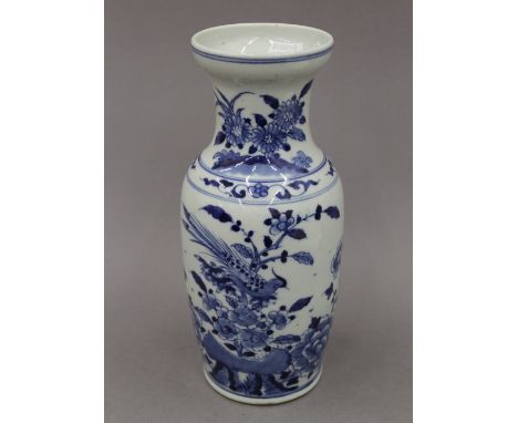 A 19th century Chinese blue and white porcelain vase, decorated with birds, flowers and rockwork. 25 cm high.