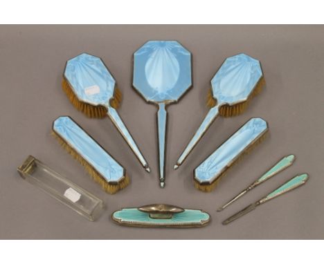 A quantity of enamel decorated silver dressing table wares. The largest 31 cm long.