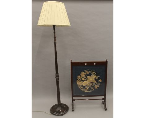 A tapestry inset fire screen and a standard lamp. The former 63.5 cm wide.
