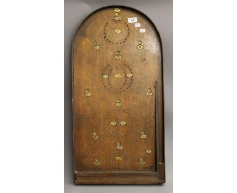 A vintage wooden Bagatelle board. 76 cm long.